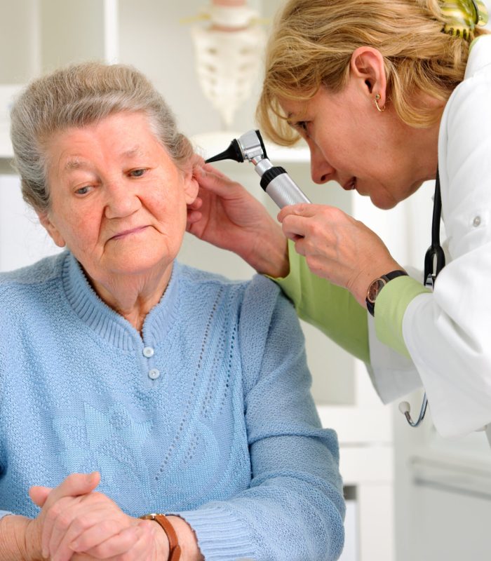 Doctor,Examining,Senior,Patient's,Ears